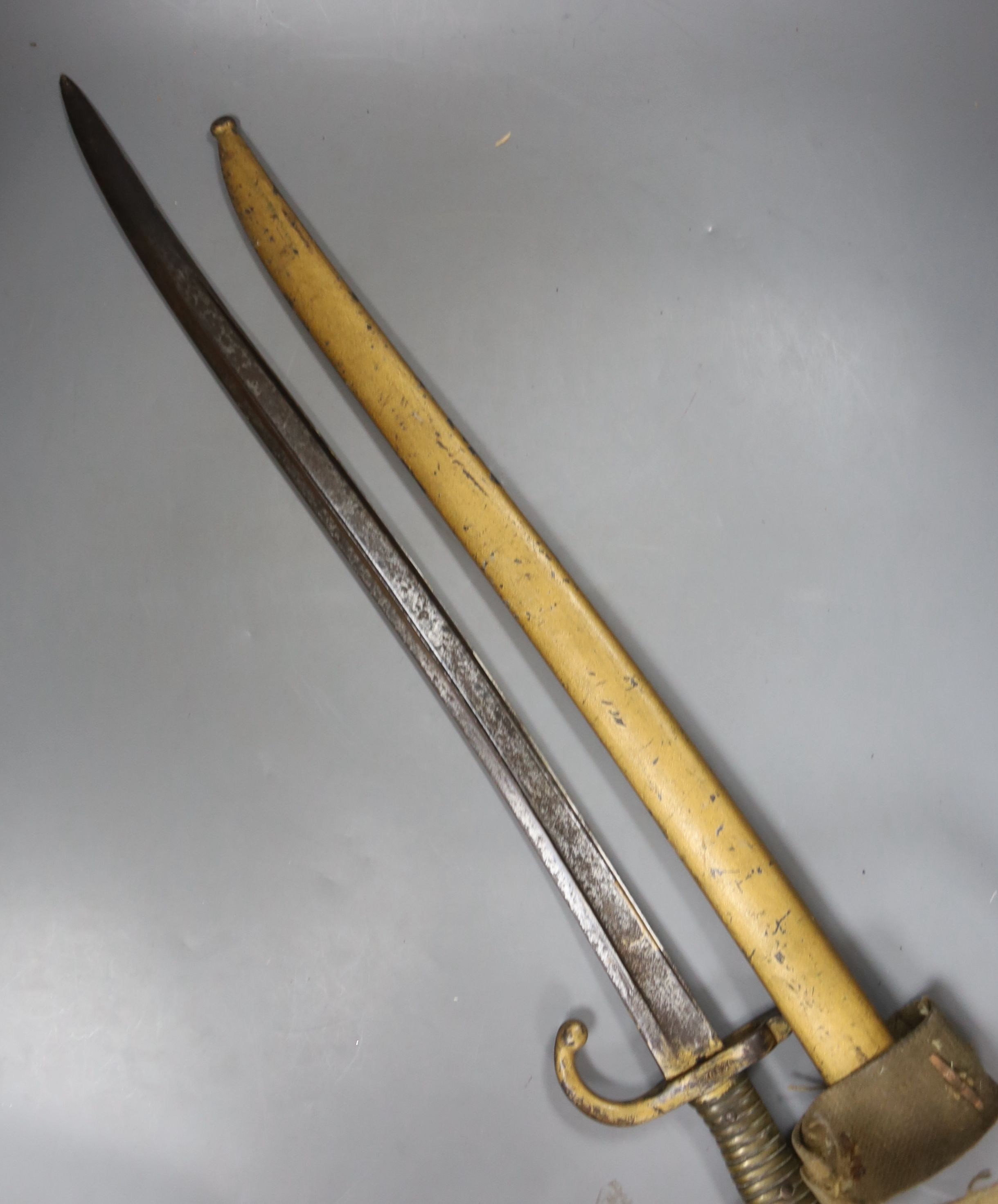 A bayonet with scabbard and a knife, bayonet 71 cms long.